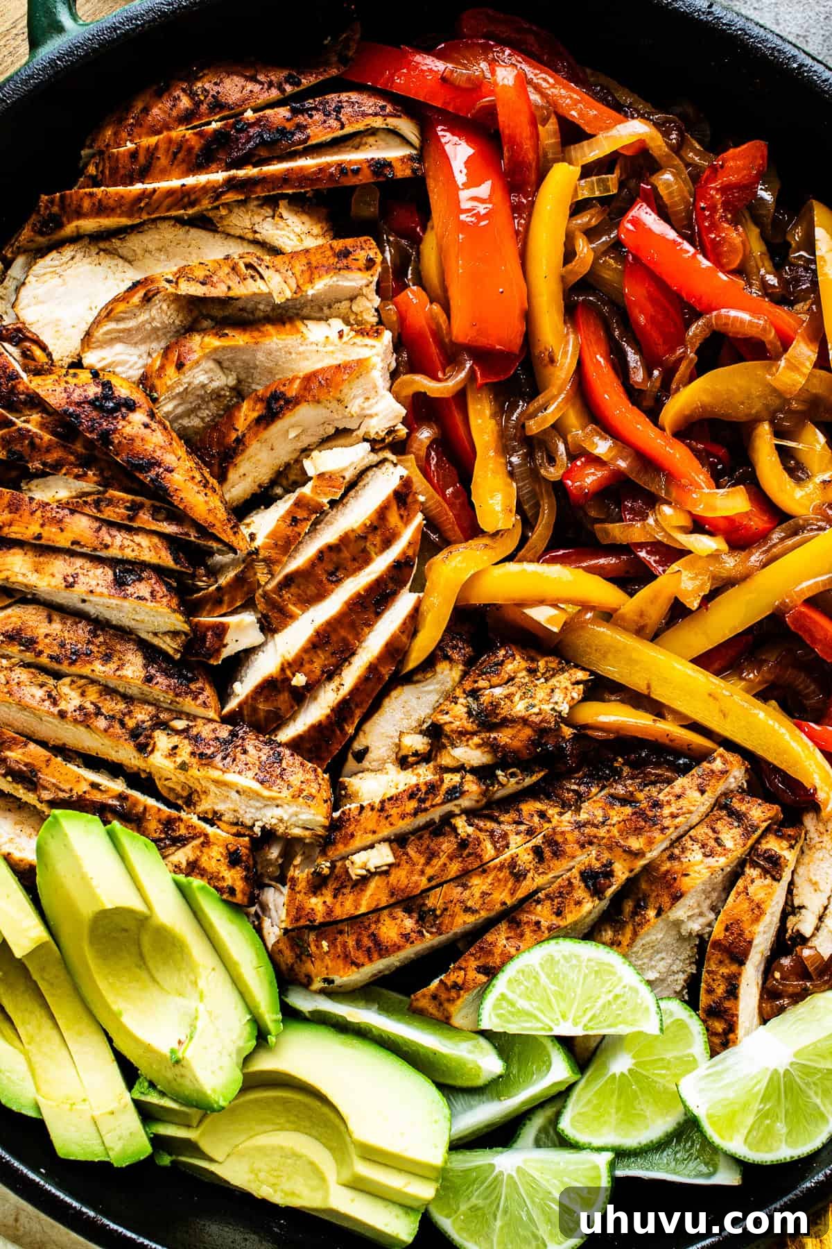 Sizzling Chicken Fajitas 7 A vibrant skillet filled with sliced chicken fajitas, tender bell peppers, and caramelized onions, ready for serving.