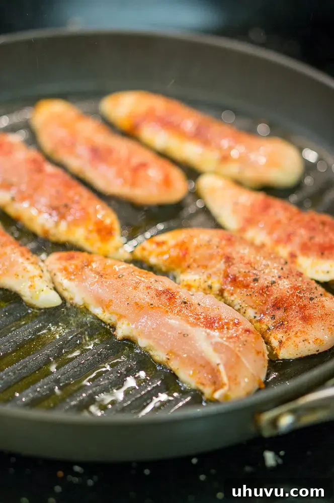 Perfectly seasoned pan-grilled chicken tenderloins ready for cooking