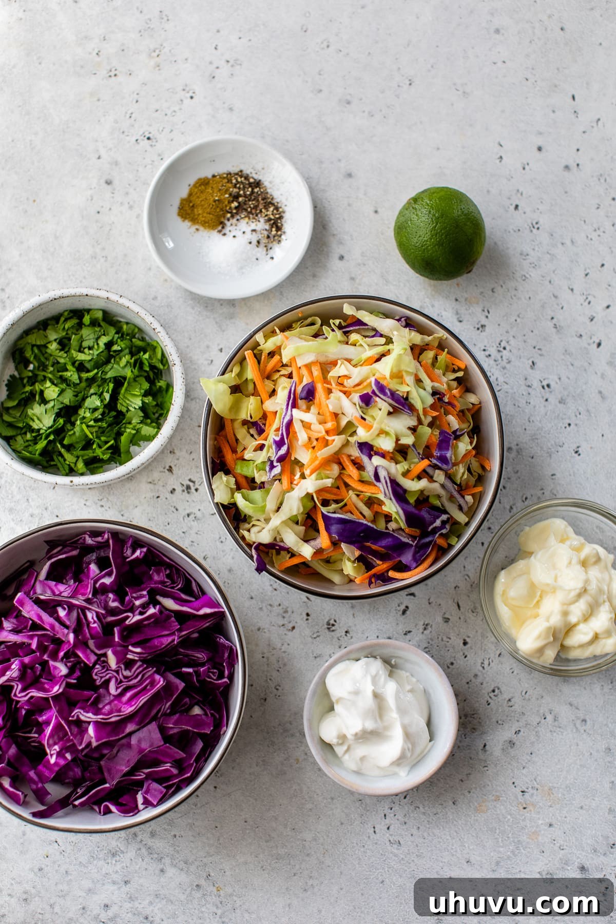 Ingredients for fish taco slaw laid out on a surface.