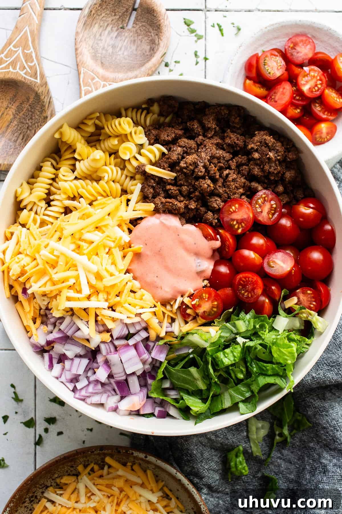 Zesty Taco Pasta Medley 6 All the vibrant ingredients for taco pasta salad, including cooled pasta and beef, arranged in a large mixing bowl before tossing.