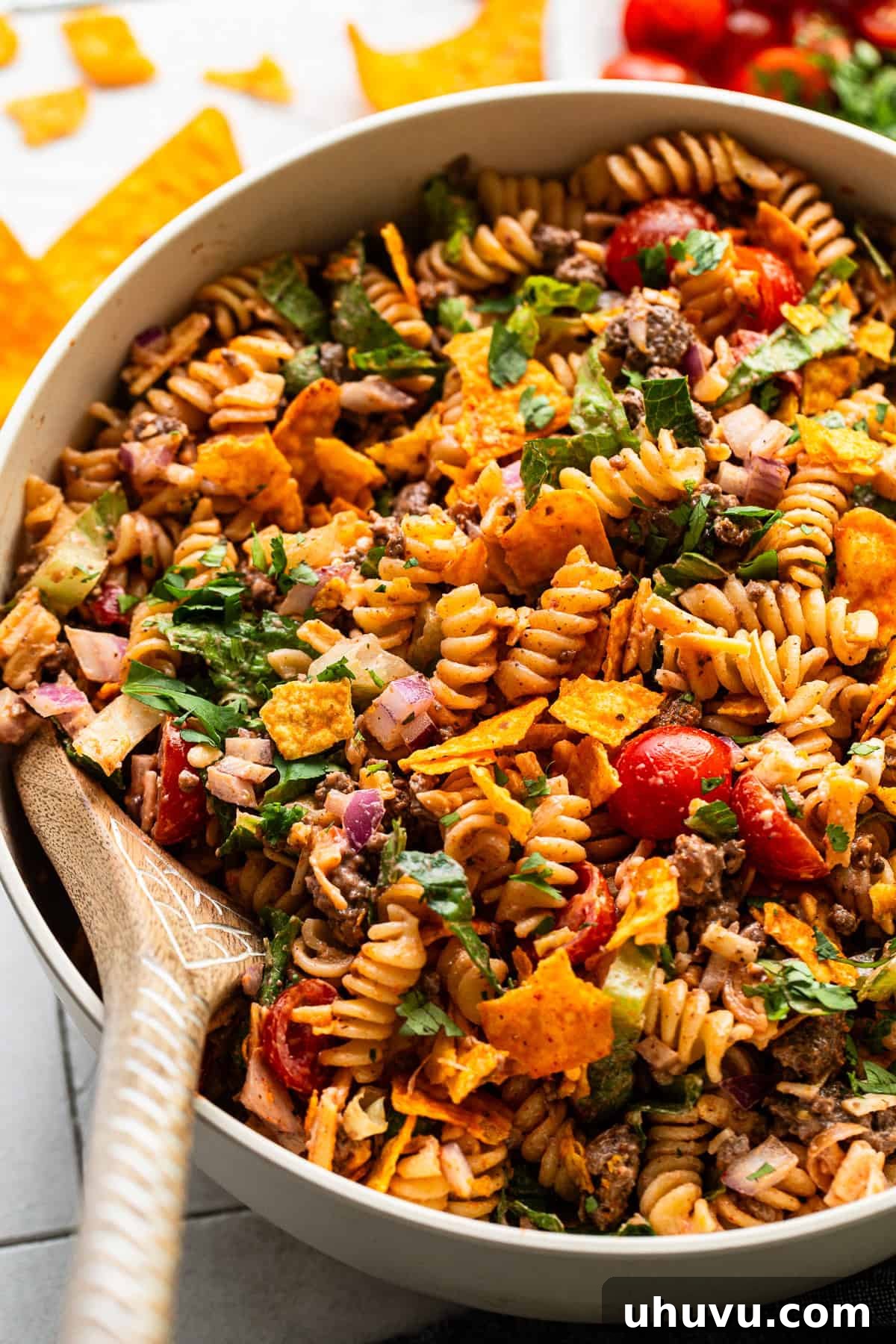 Zesty Taco Pasta Medley 8 A beautifully presented bowl of taco pasta salad, garnished with cilantro and ready to be served.