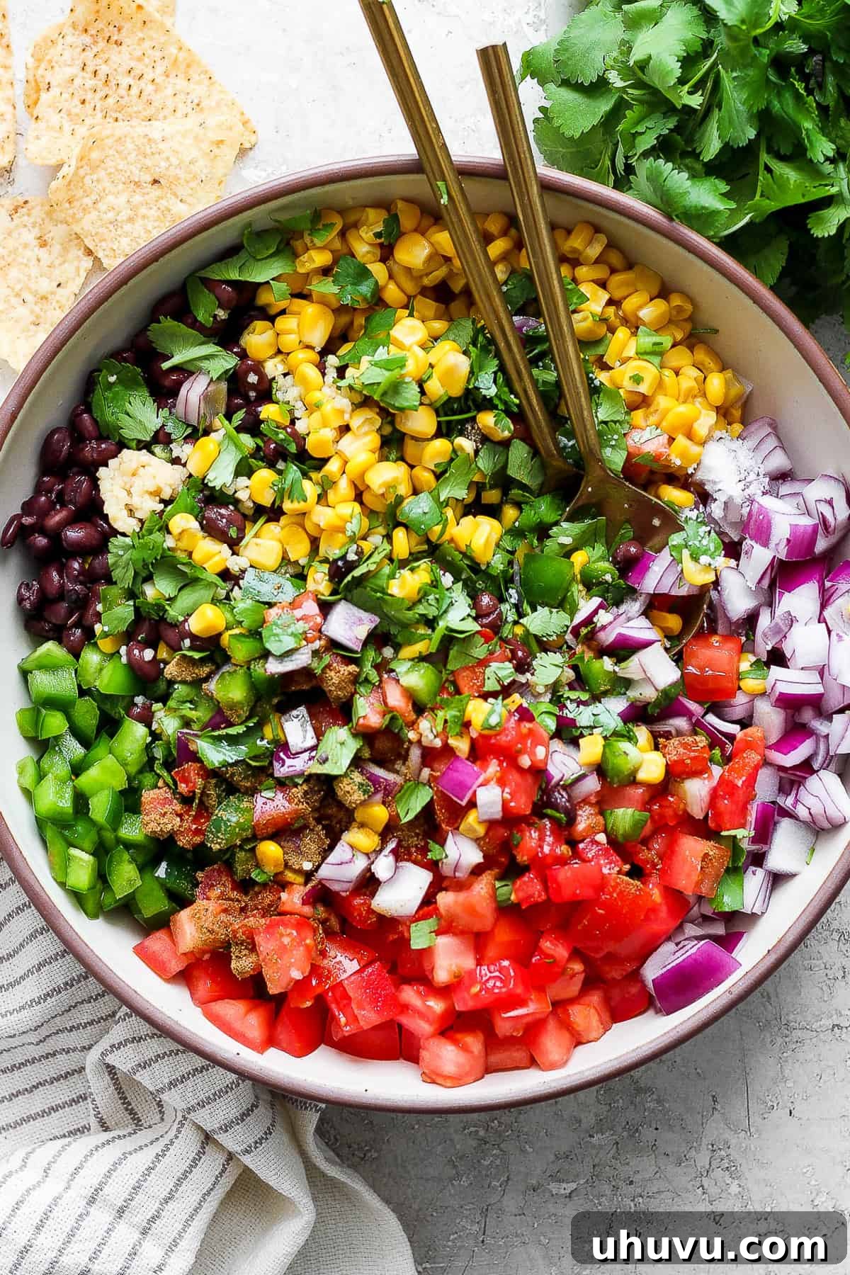 Black bean and corn salsa in a bowl with a serving spoon.