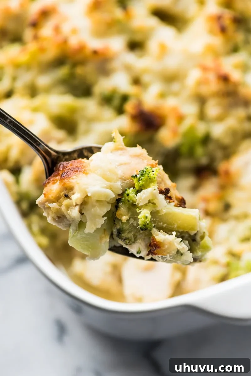 A serving of the cheesy low-carb broccoli cauliflower rice chicken casserole, showing the tender chicken and vegetable blend.