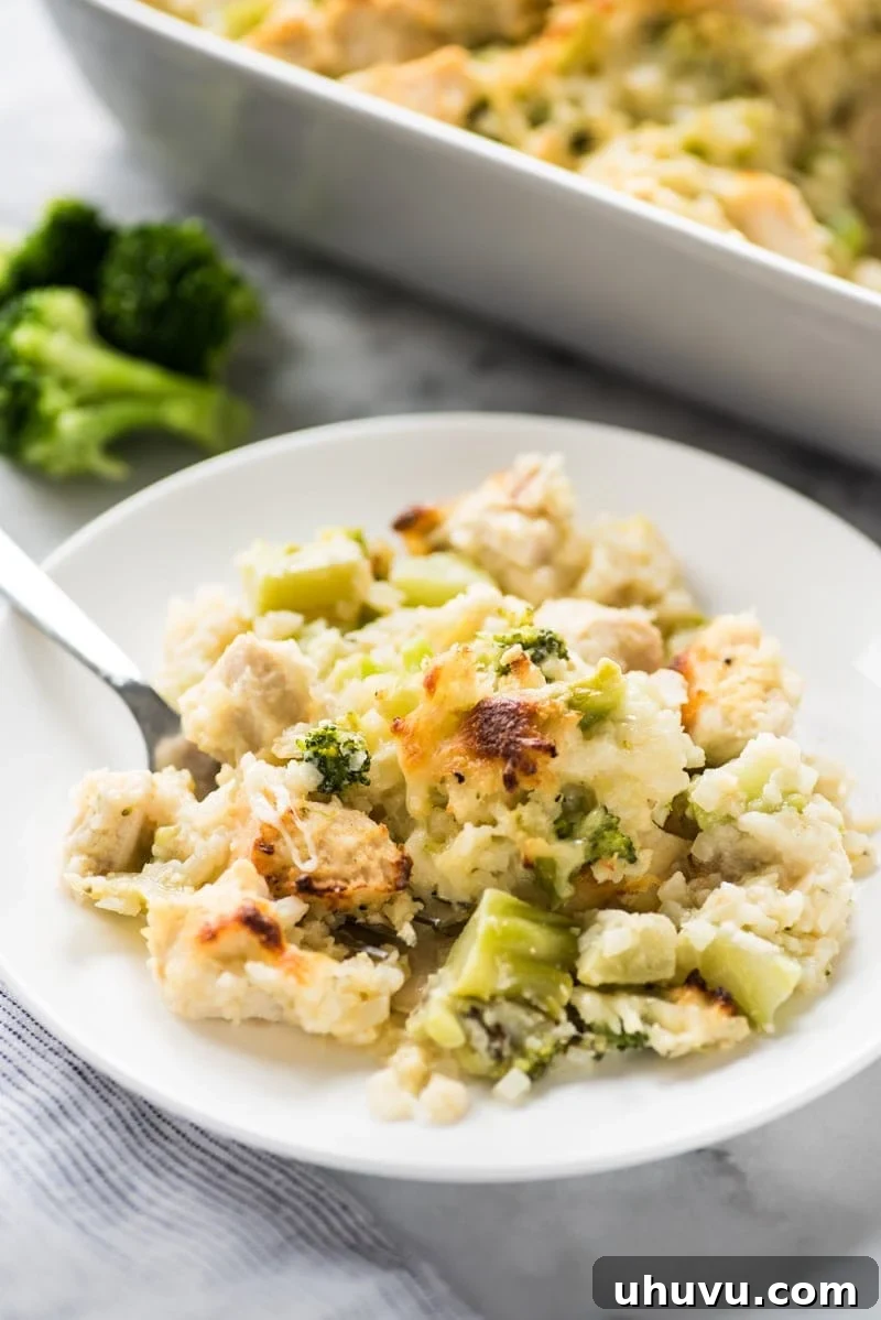 A close-up of a serving of the cheesy low-carb chicken casserole, garnished with fresh herbs, ready to be enjoyed.