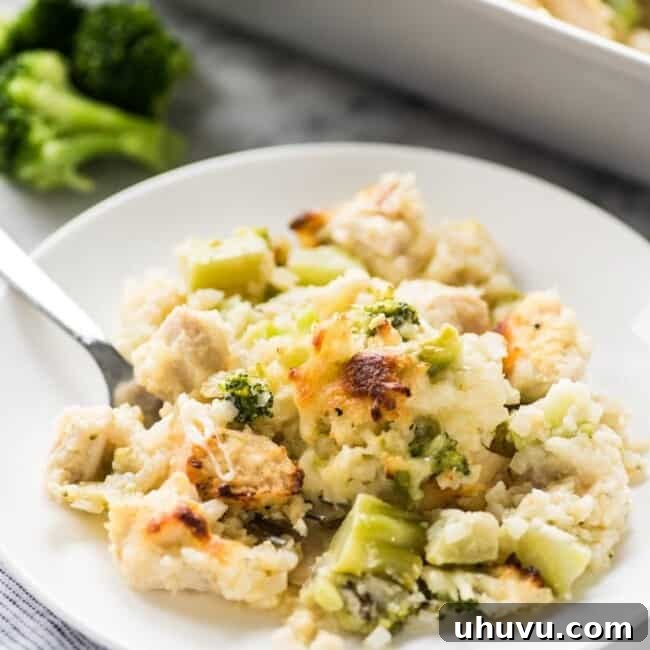 A close-up of the fully baked cheesy low-carb broccoli cauliflower rice chicken casserole, golden and bubbly.