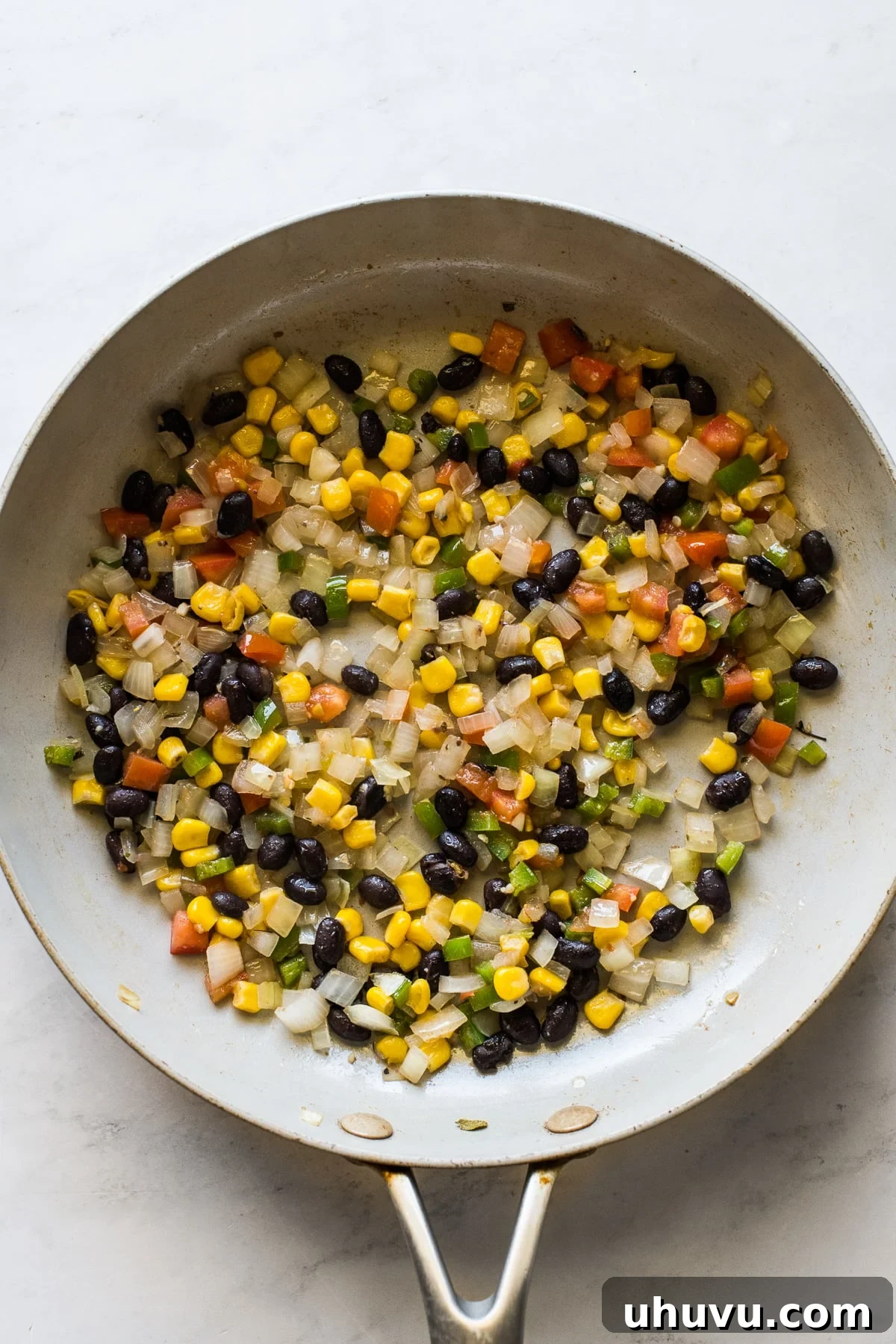 Fiesta Omelet 4 Flavorful sautéed vegetable and black bean filling simmering in a skillet, ready for a Mexican omelet.