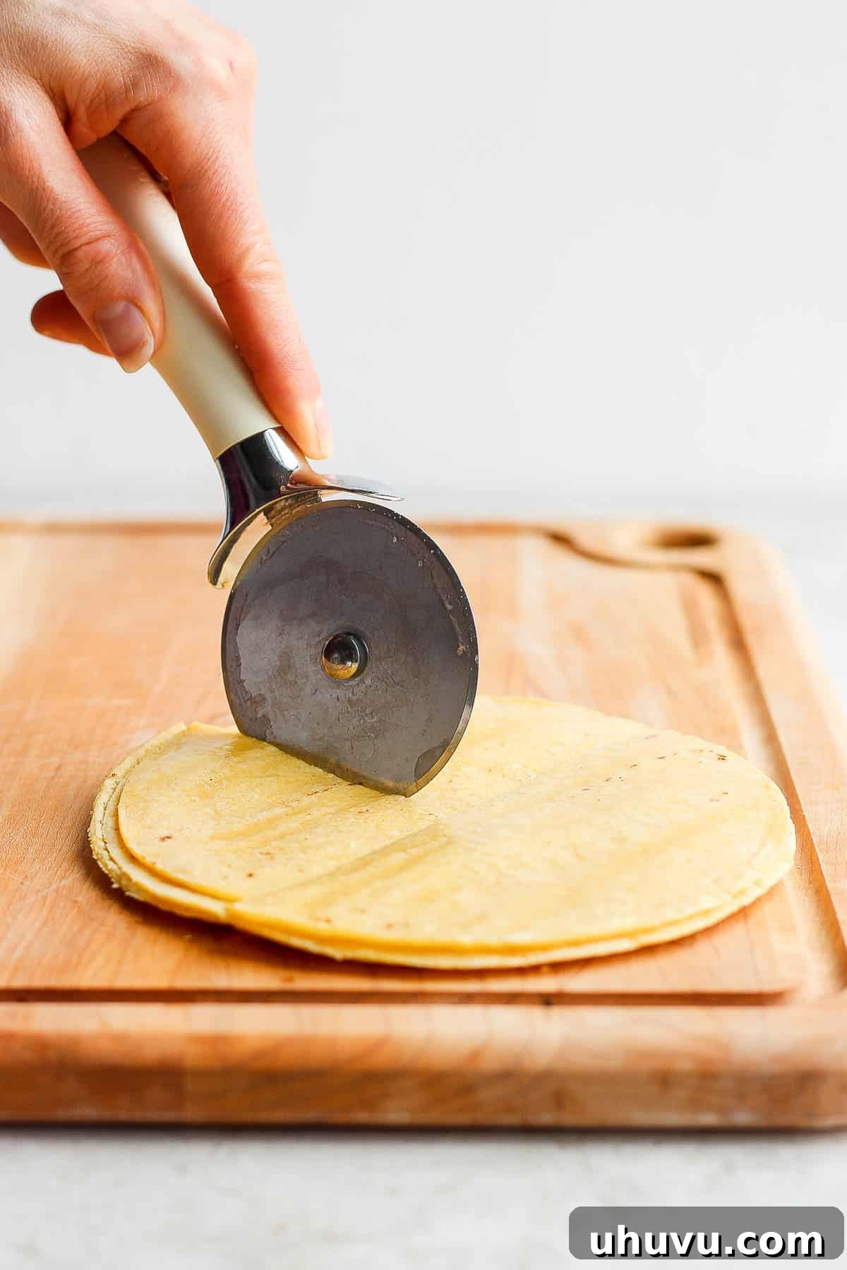Multiple tortillas stacked and cut into quarters with a pizza cutter