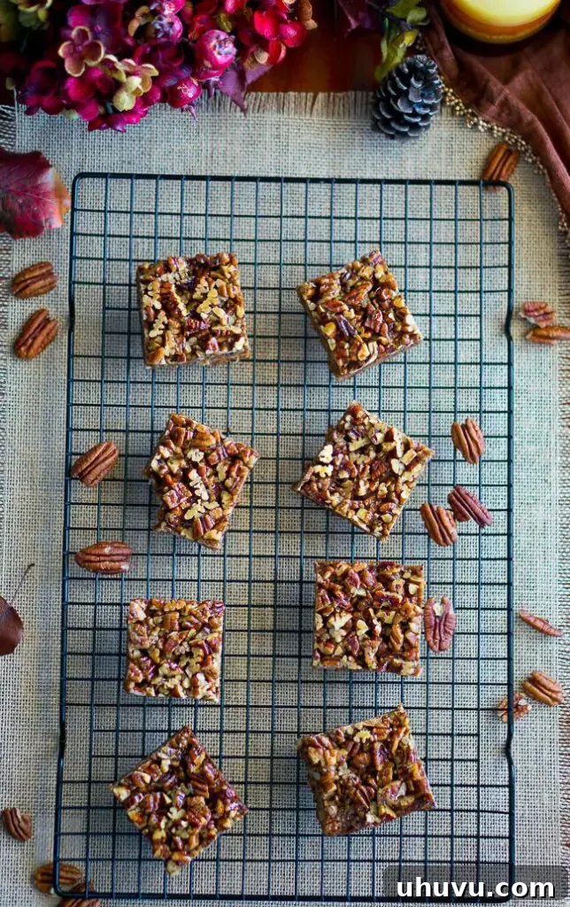A single Paleo Pecan Pie Bar on a white plate, ready to be enjoyed.