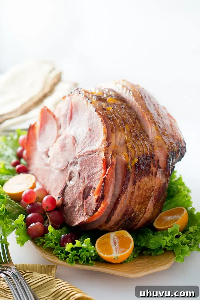 Close-up of a glazed spiral ham showing the crispy, sweet crust and juicy interior.