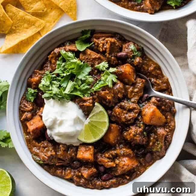 Pork chili in a bowl made from beans, sweet potatoes, pork shoulder, and chipotle spices.