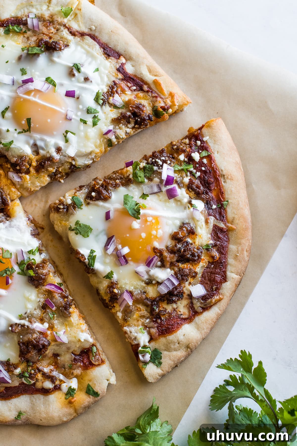 Morning Fiesta Pizza 7 A perfectly baked slice of Mexican Breakfast Pizza showcasing the runny egg yolk, chorizo, and melted cheese on a crisp crust.