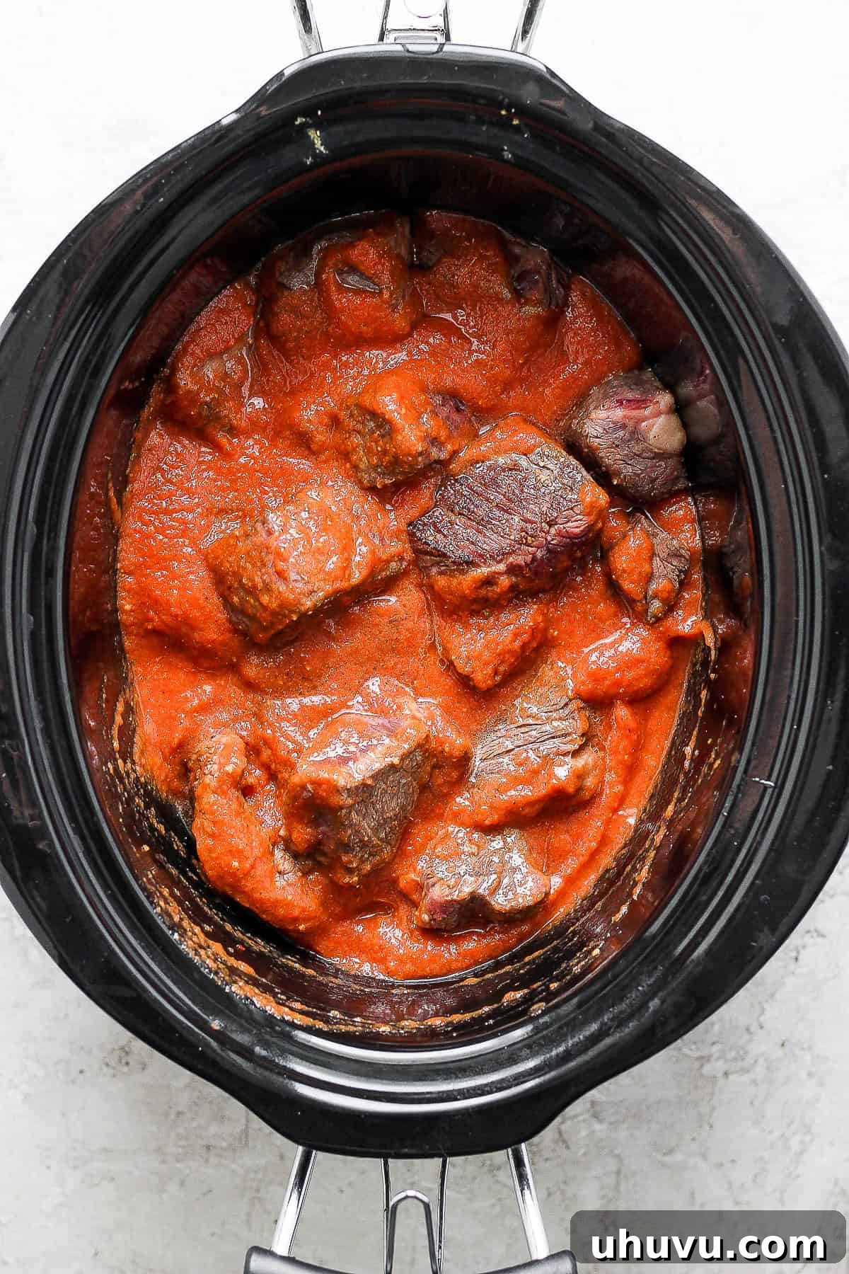 Smoky Chipotle Shredded Beef 9 Tinga sauce poured into the crockpot with cooked meat