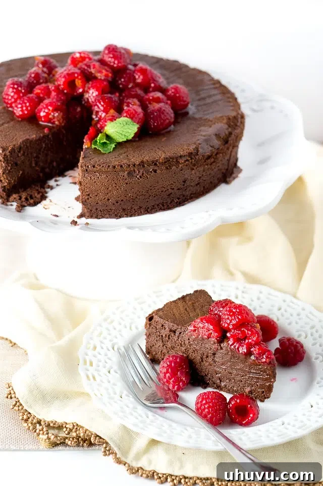 Close-up of a perfectly baked Paleo Flourless Chocolate Cake with a smooth, glossy top, cooling on a wire rack, highlighting its flawless texture.