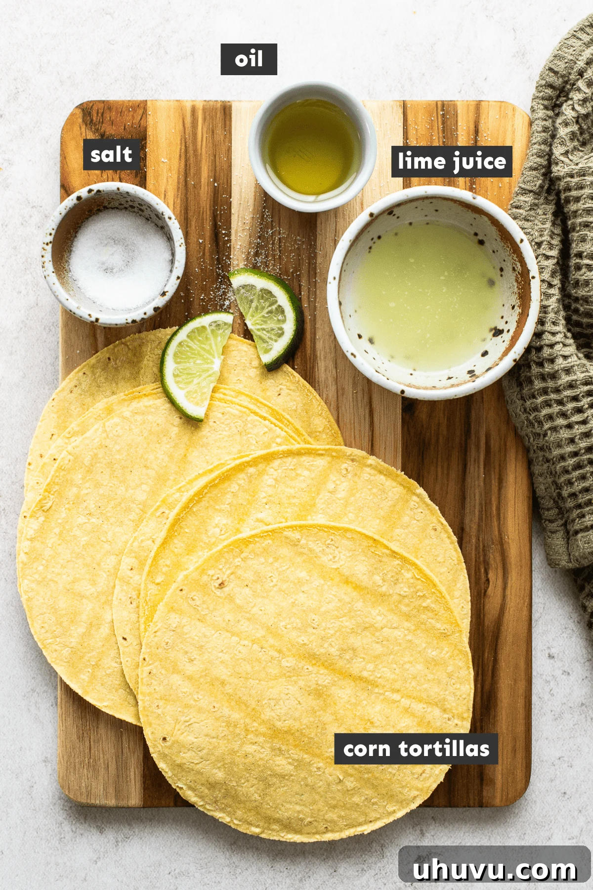 Crispy Oven-Baked Tortilla Chips 3 Ingredients for baked tortilla chips including corn tortillas, oil, lime, and salt on a wooden table.