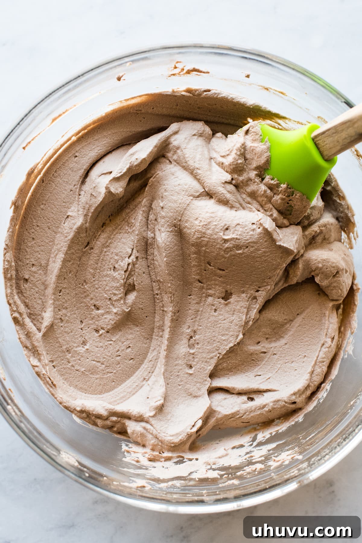 Fluffy chocolate whipped cream in a mixing bowl.