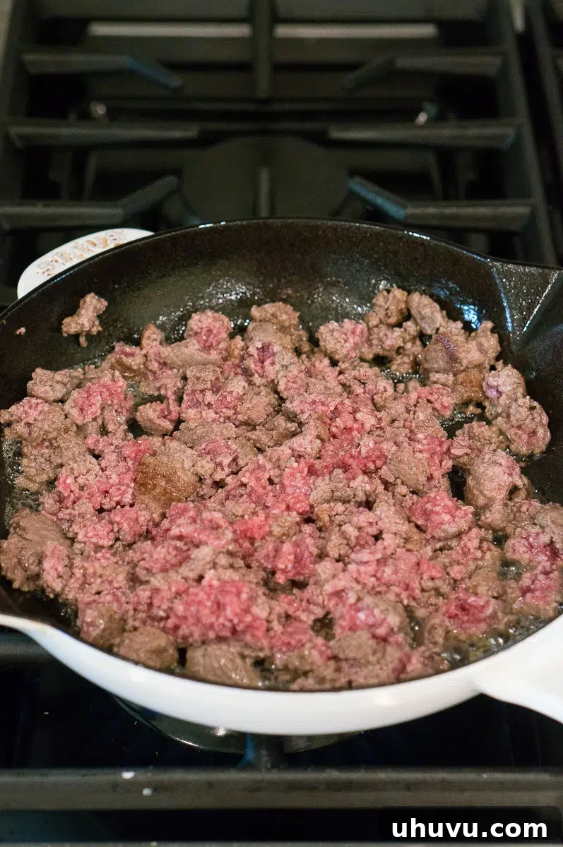 ground beef browning in a skillet