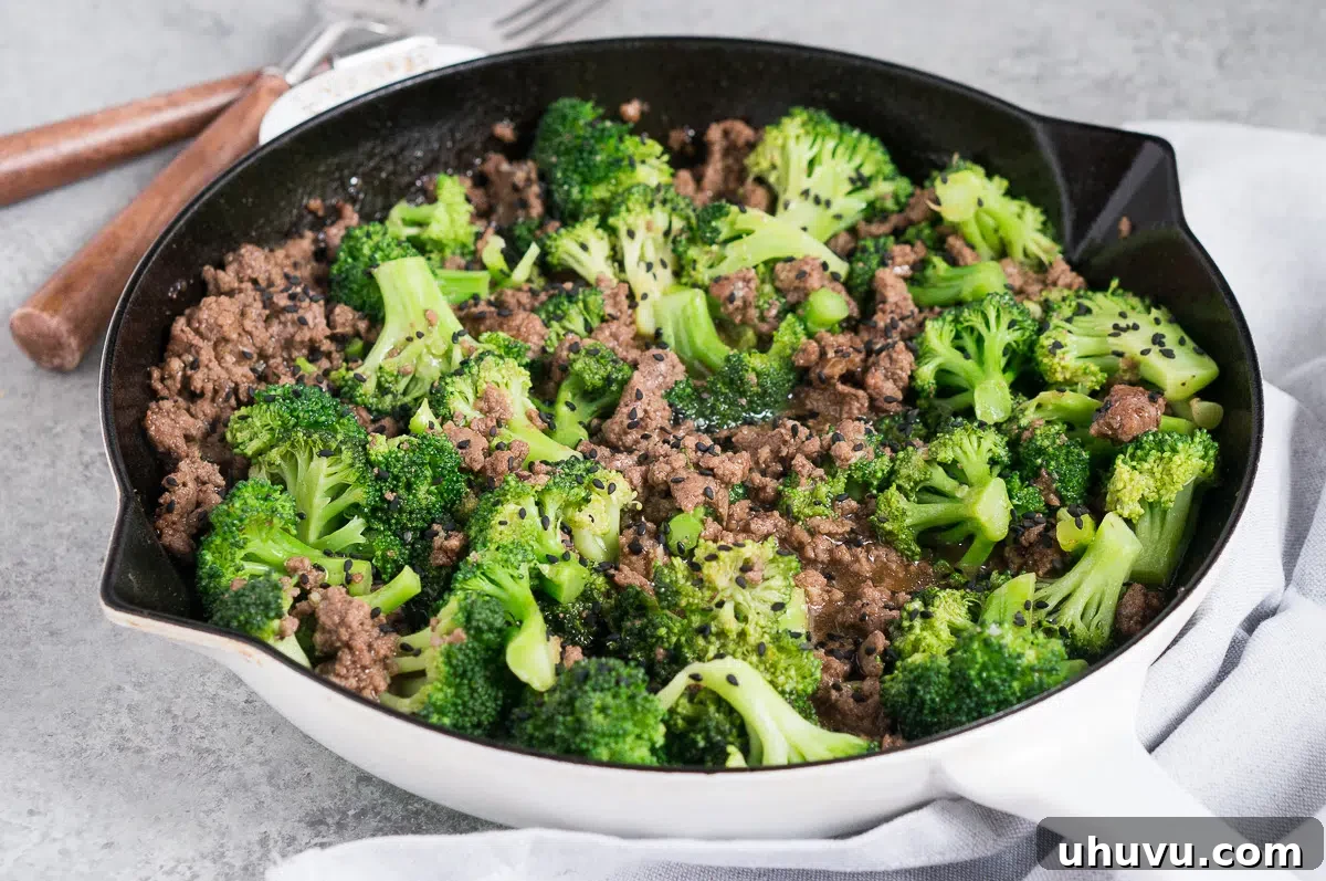 ground beef and broccoli stir fry in a skillet, beautifully cooked