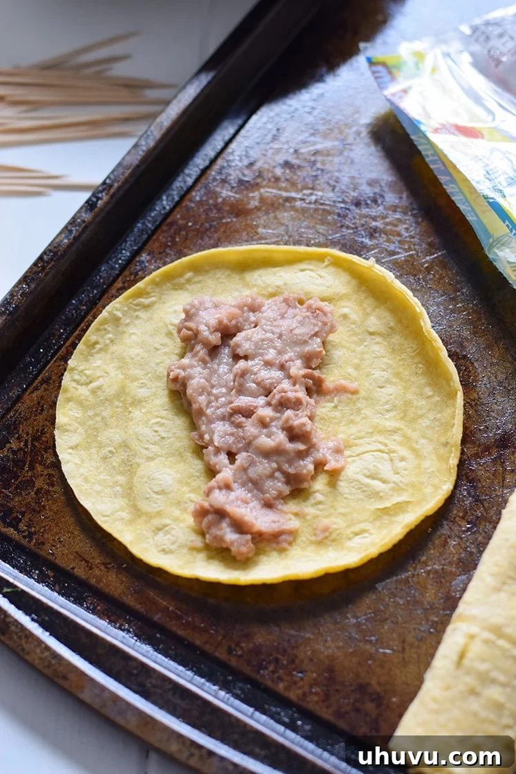 Warming corn tortillas to prevent cracking before filling.