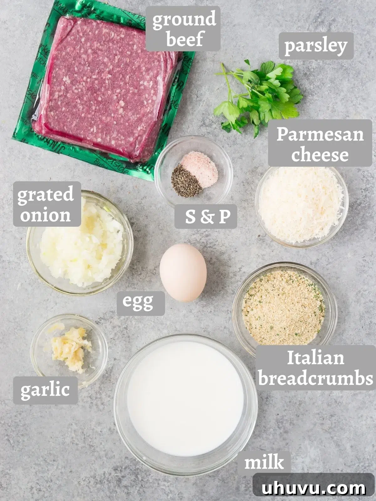 Ingredients for homemade Italian meatballs laid out on a table