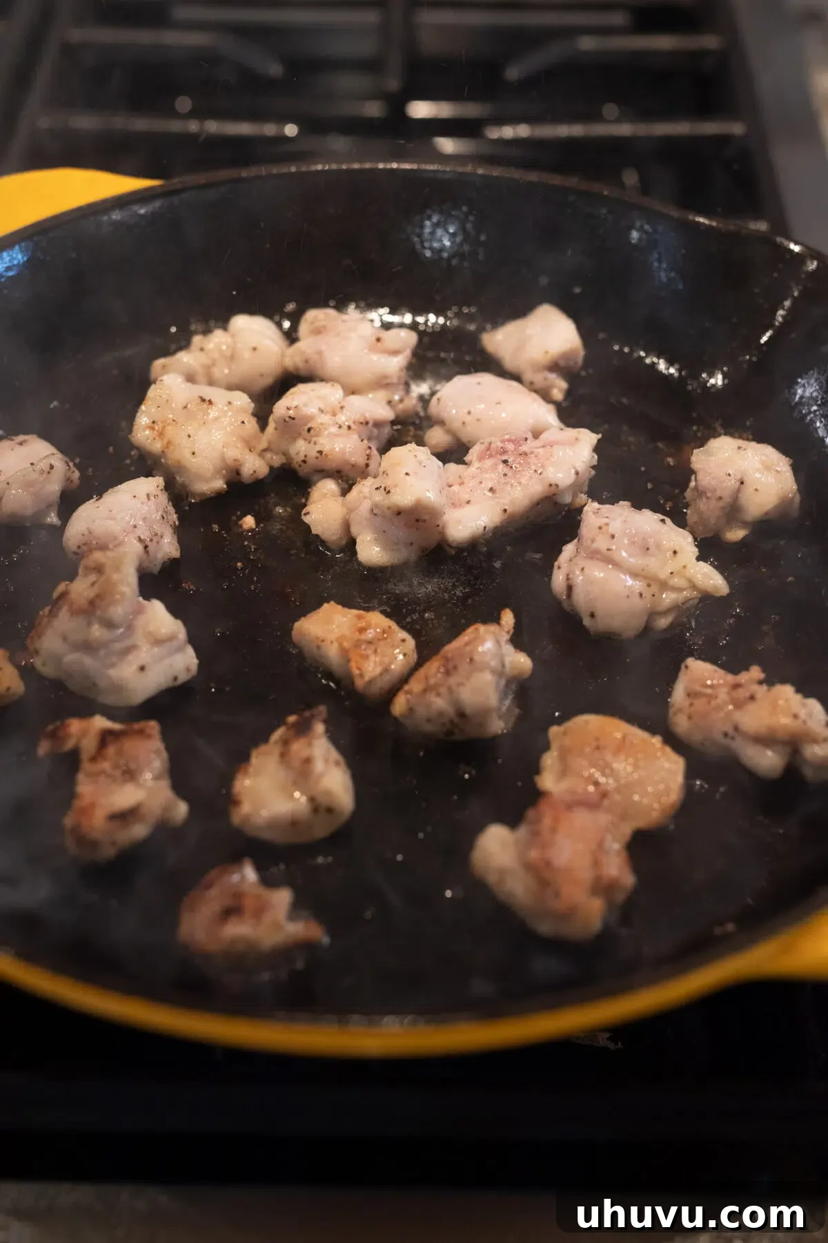 cooking seasoned chicken in a skillet until golden brown