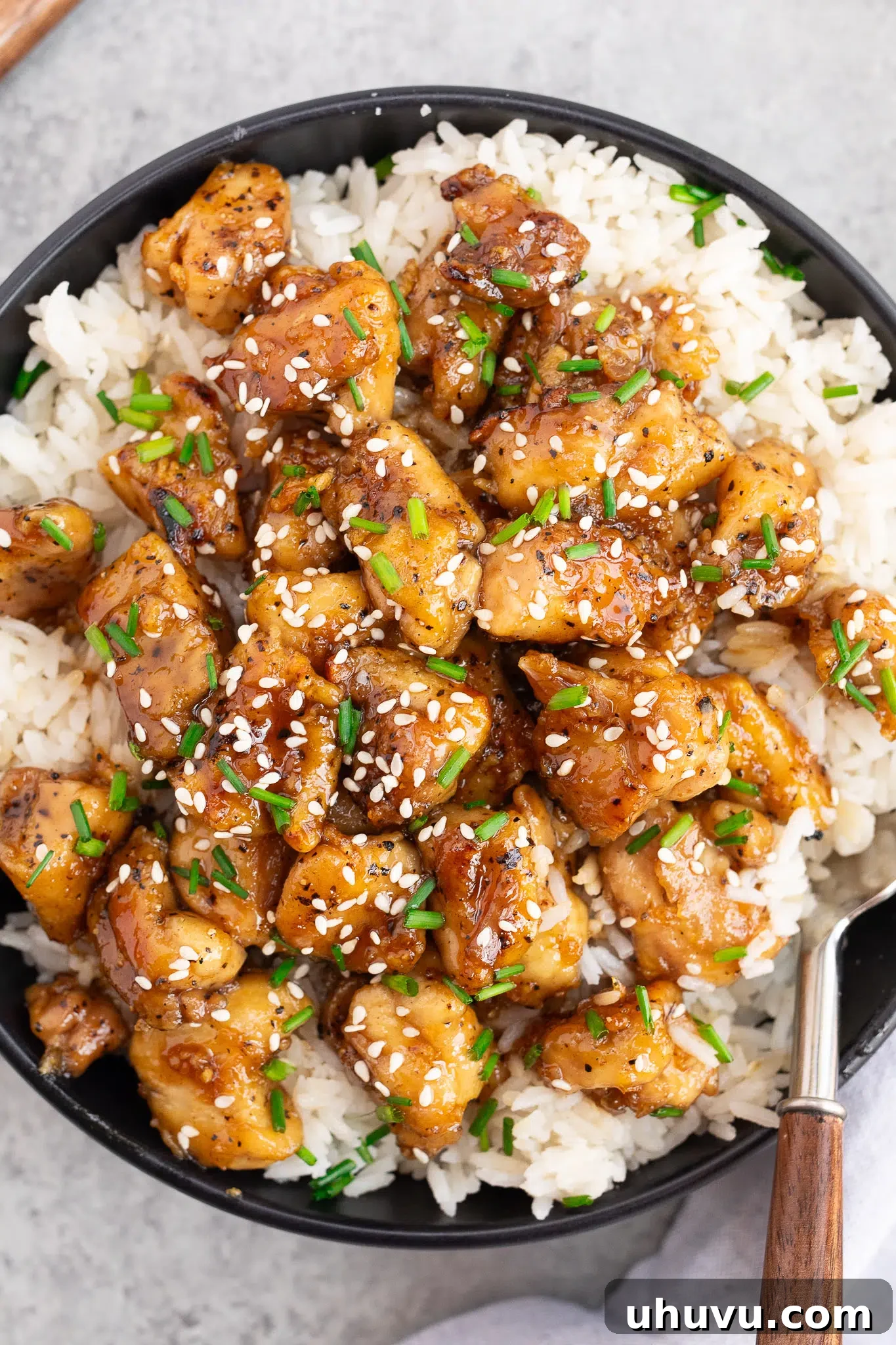 close up image of honey garlic chicken with sauce over rice