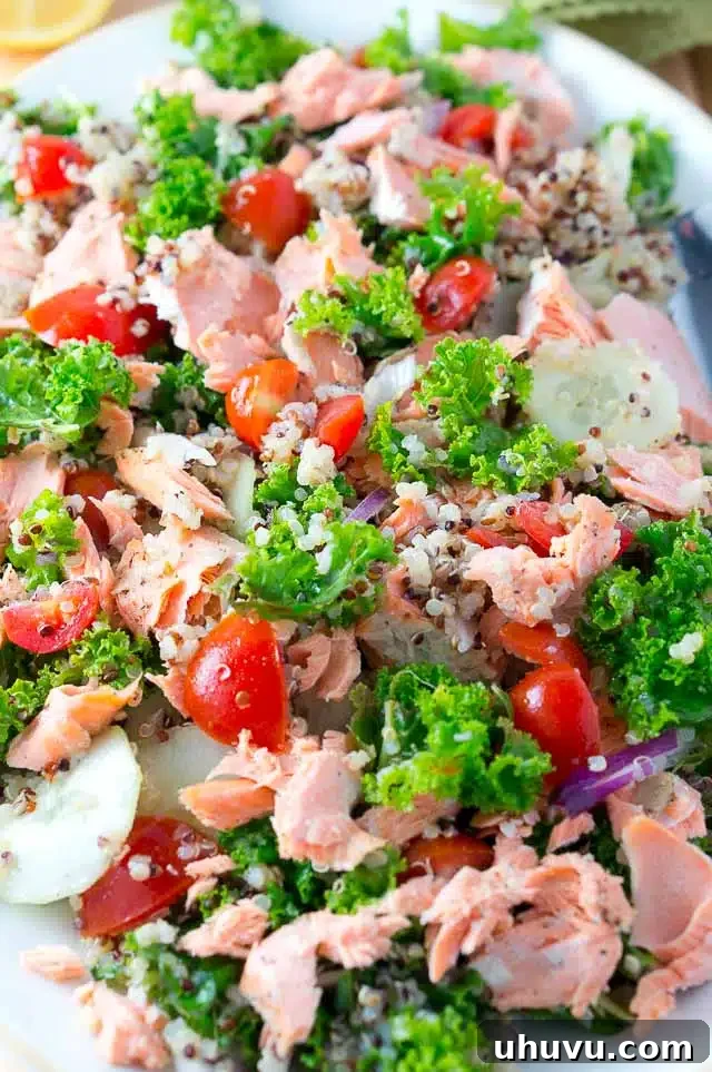 Delicious Salmon Quinoa and Kale Salad that is bursting with flavor and healthy ingredients. Perfect weeknight dinner - 15 min. to cook and easy prep work.