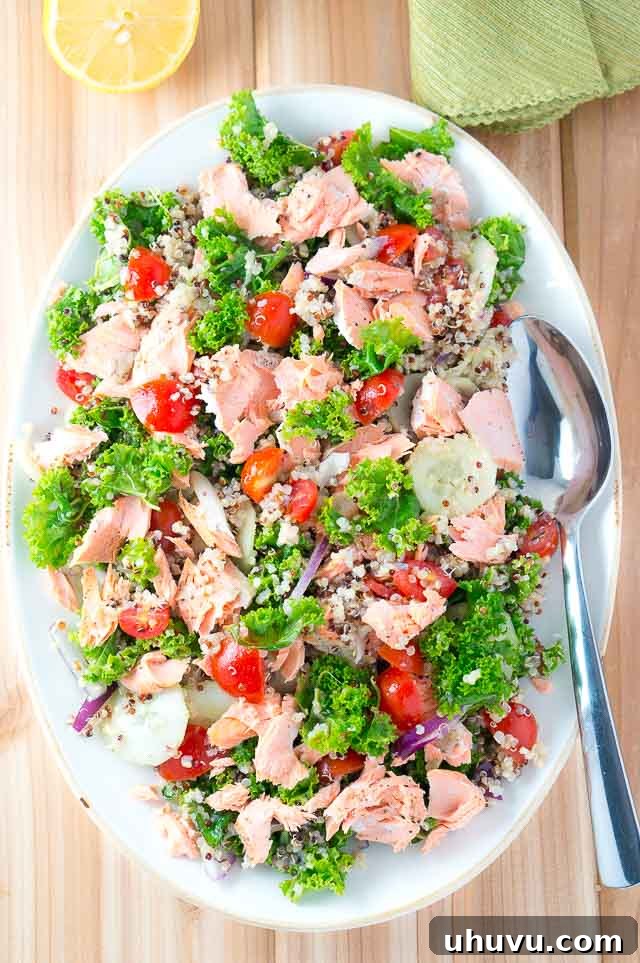 Delicious Salmon Quinoa and Kale Salad that is bursting with flavor and healthy ingredients. Perfect weeknight dinner - 15 min. to cook and easy prep work.