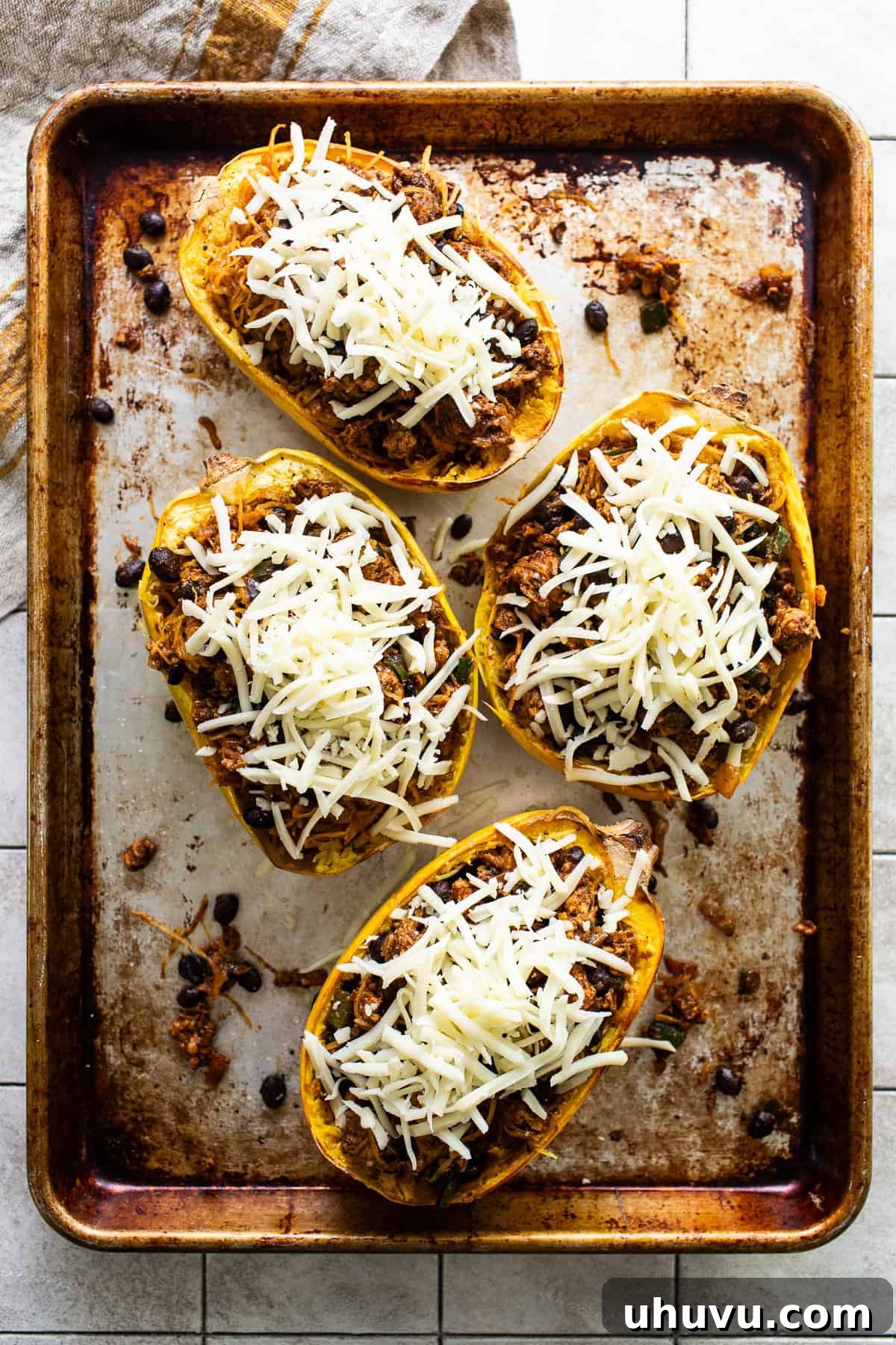 Hearty Spaghetti Squash Bake 8 Shredded cheese topped on spaghetti squash boats.