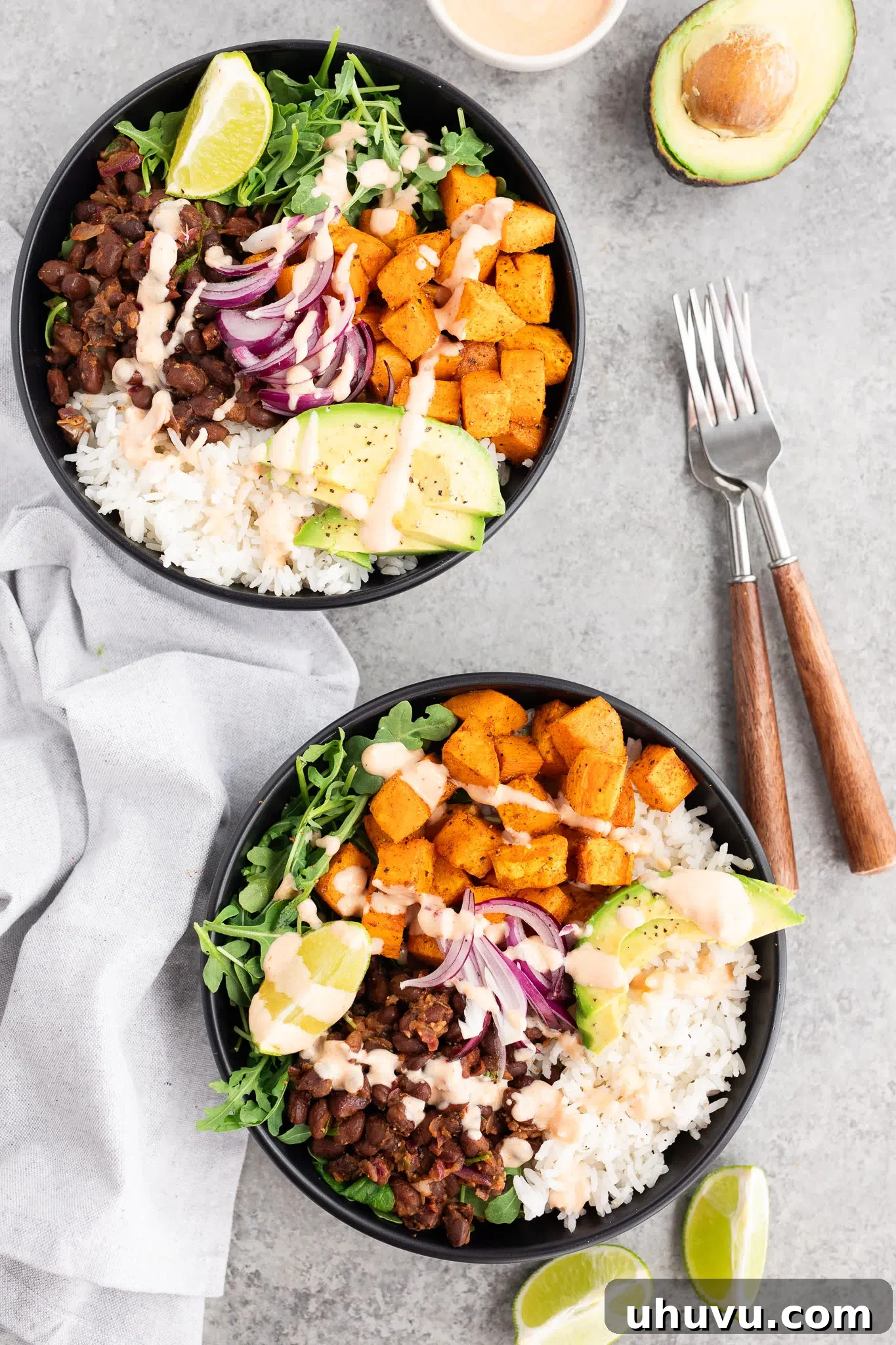 Vibrant Sweet Potato Black Bean Bowls 11 two bowls with rice, arugula, sweet potatoes and black beans ready to be served