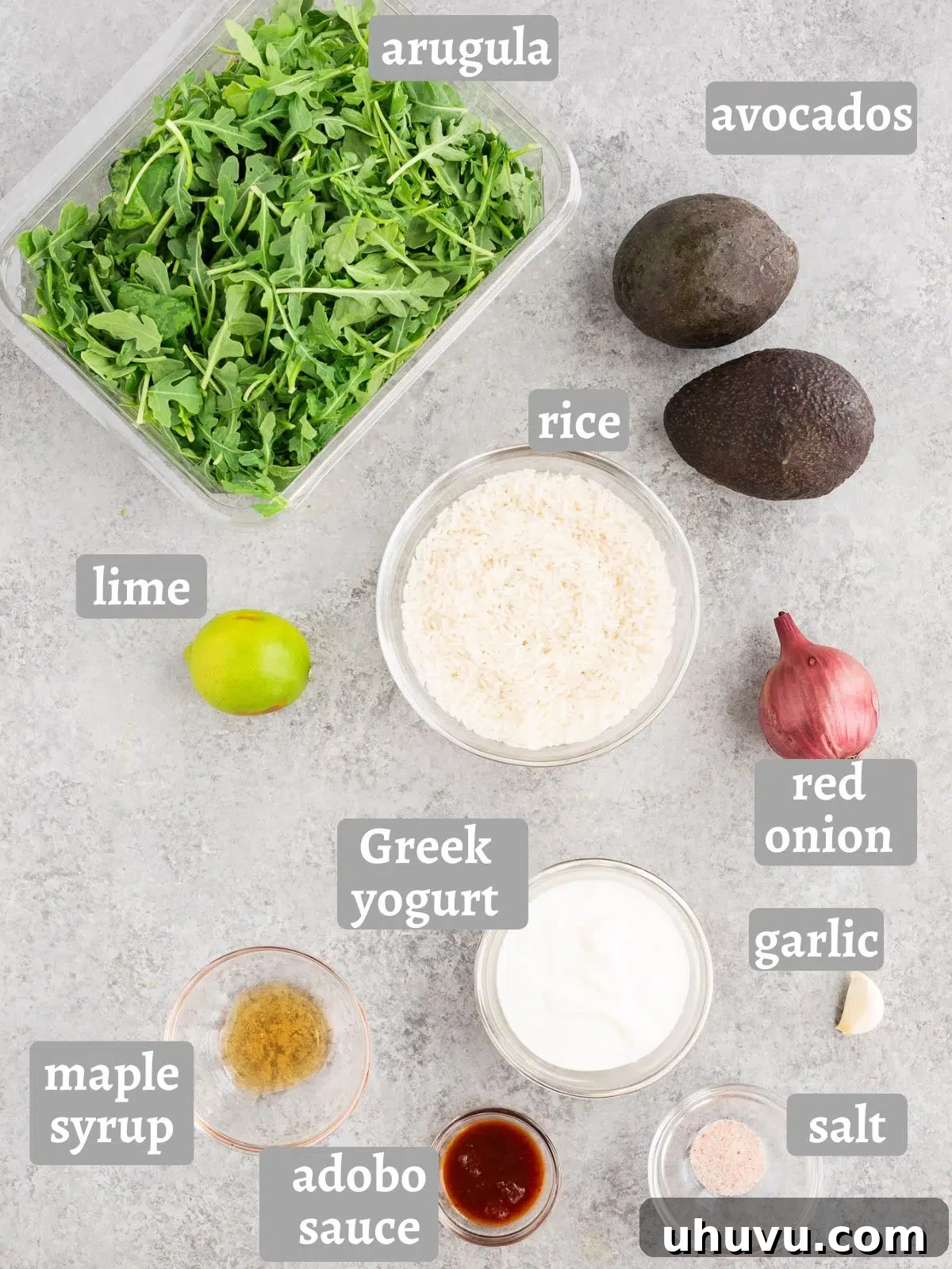 Vibrant Sweet Potato Black Bean Bowls 5 arugula, avocados, rice and Chipotle Lime crema ingredients on a table