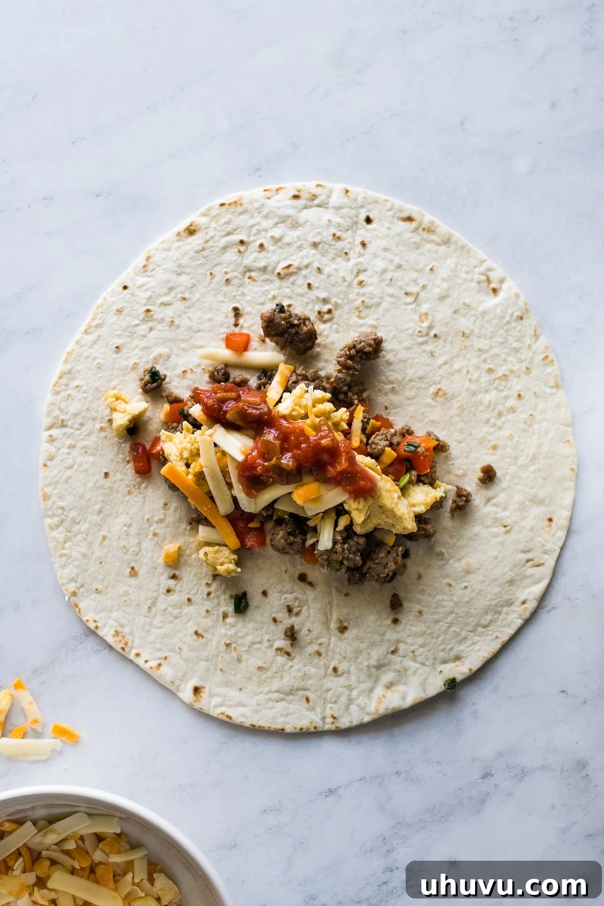 Sunrise Scramble Wraps 3 A flour tortilla loaded with cooked breakfast sausage, scrambled eggs, chunky salsa, and shredded cheese.