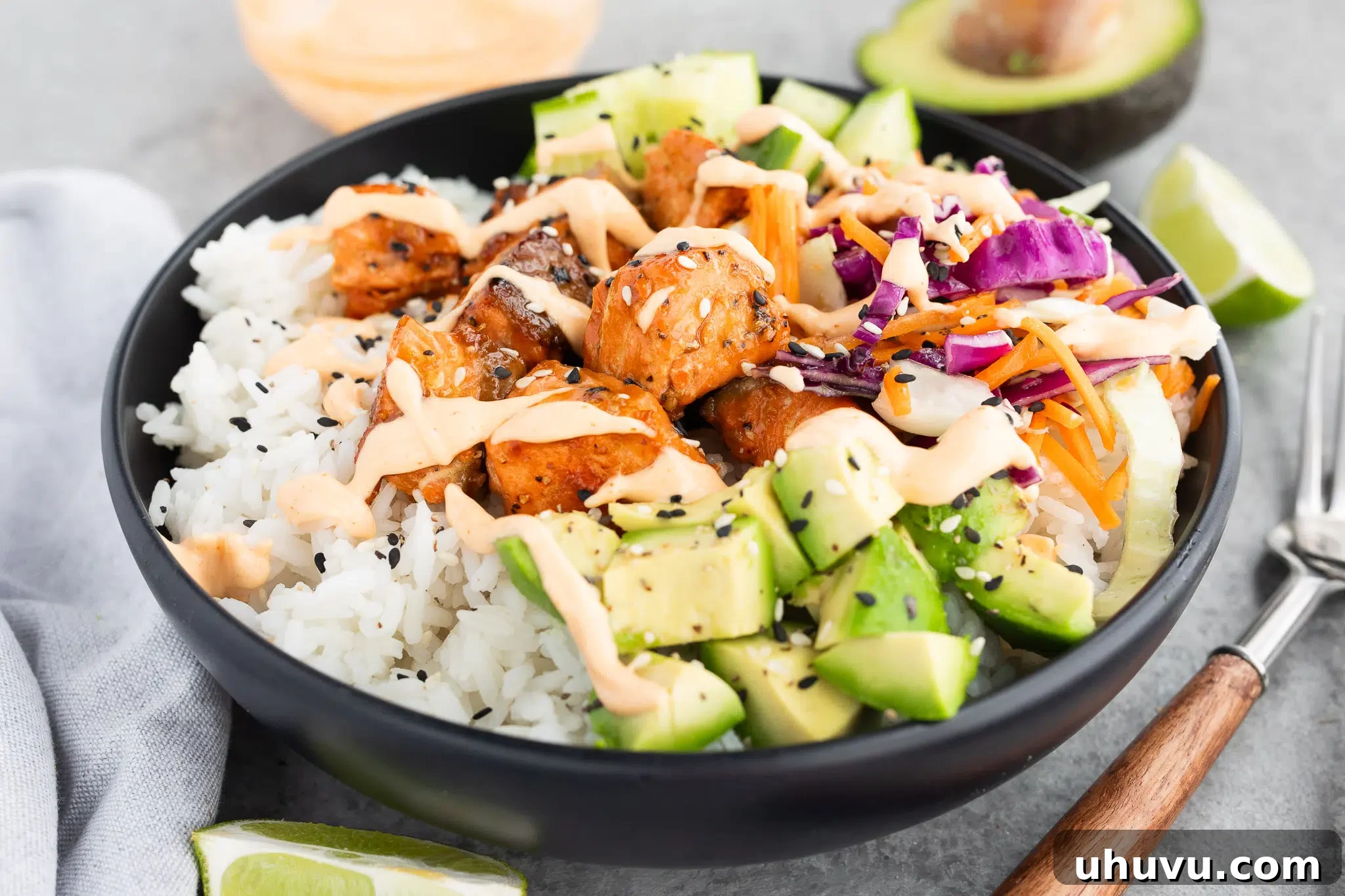 Close-up of a delicious salmon rice bowl with vibrant vegetables.