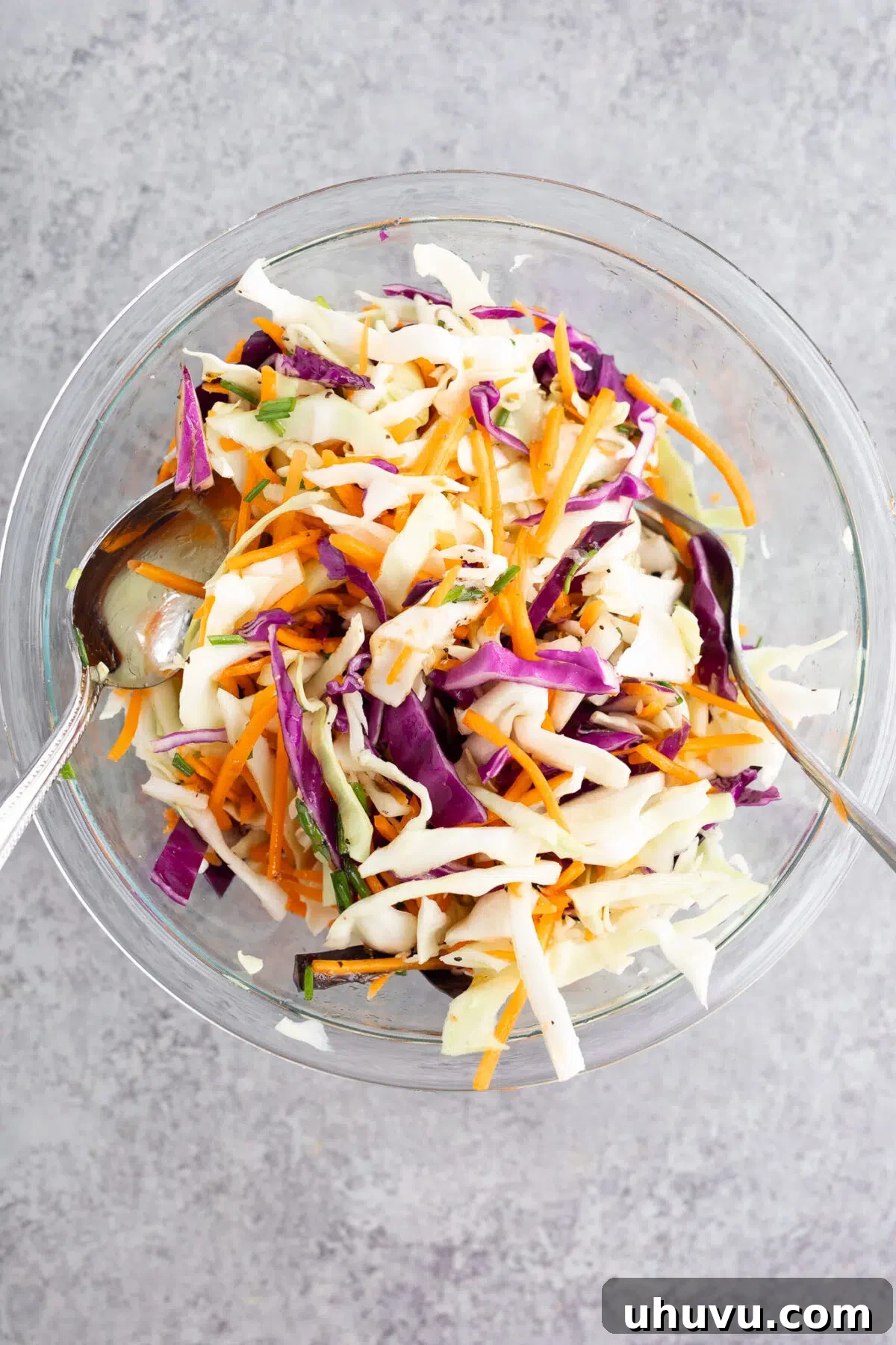 Preparing the fresh and crunchy coleslaw mixture in a large bowl.