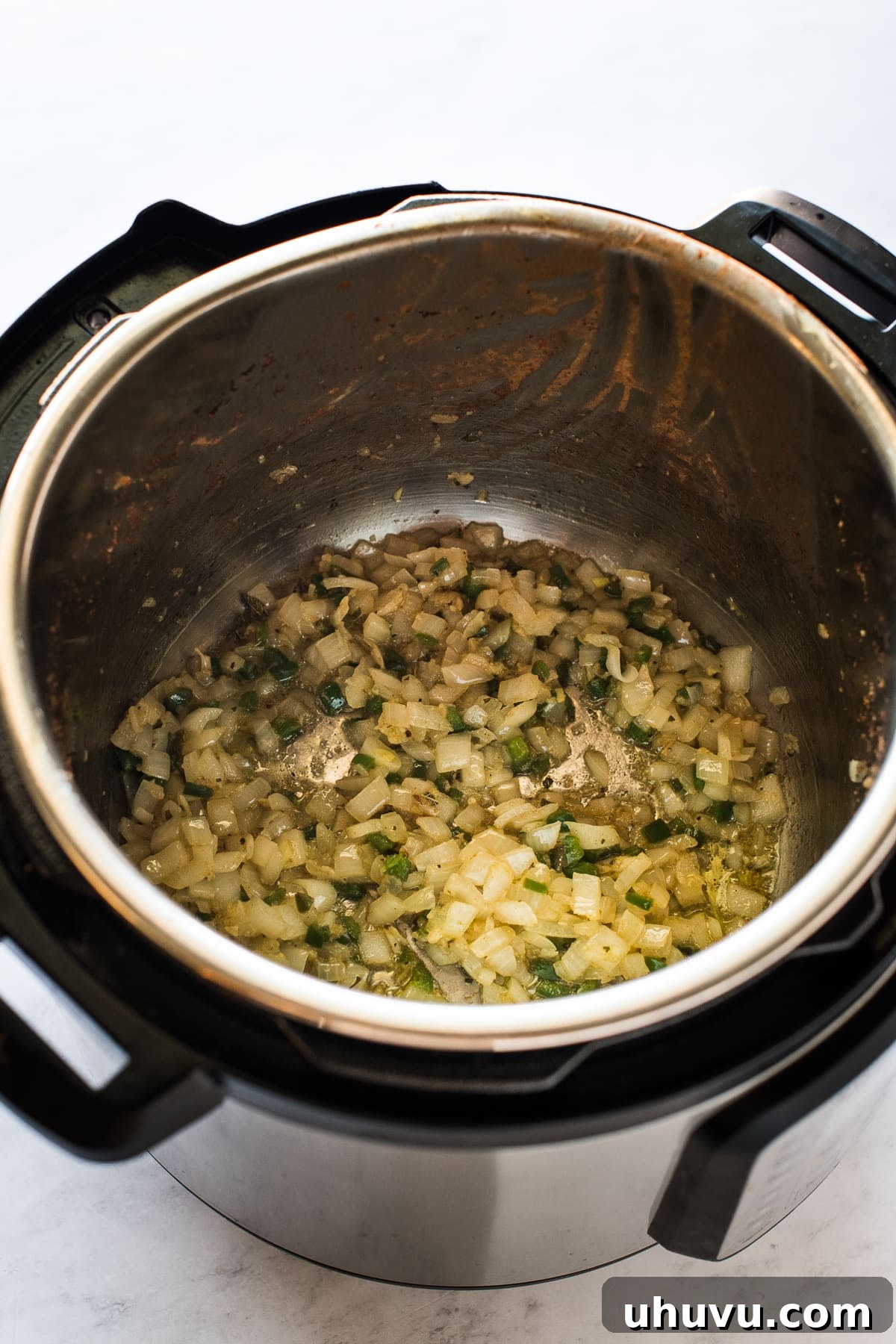 Quick and Creamy Instant Pot Refried Beans 5 Sauteed onions, jalapenos, and garlic in an Instant Pot