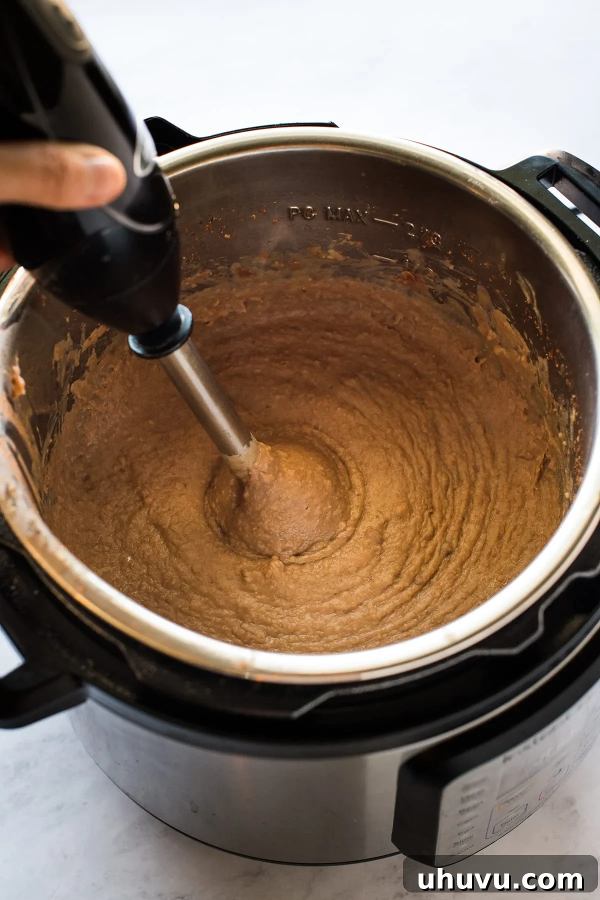 Quick and Creamy Instant Pot Refried Beans 7 Refried beans in the Instant Pot being blended.