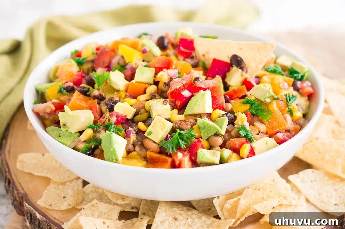 Large serving bowl of Cowboy Caviar on a wooden table