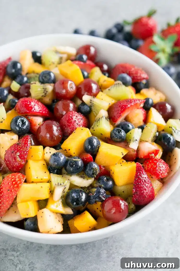 A serving of fruit salad dessert with honey lime dressing