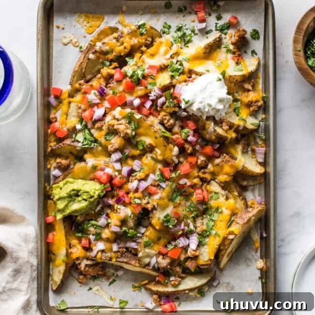 Loaded baked potato wedges made from potato wedges covered in melted cheese.