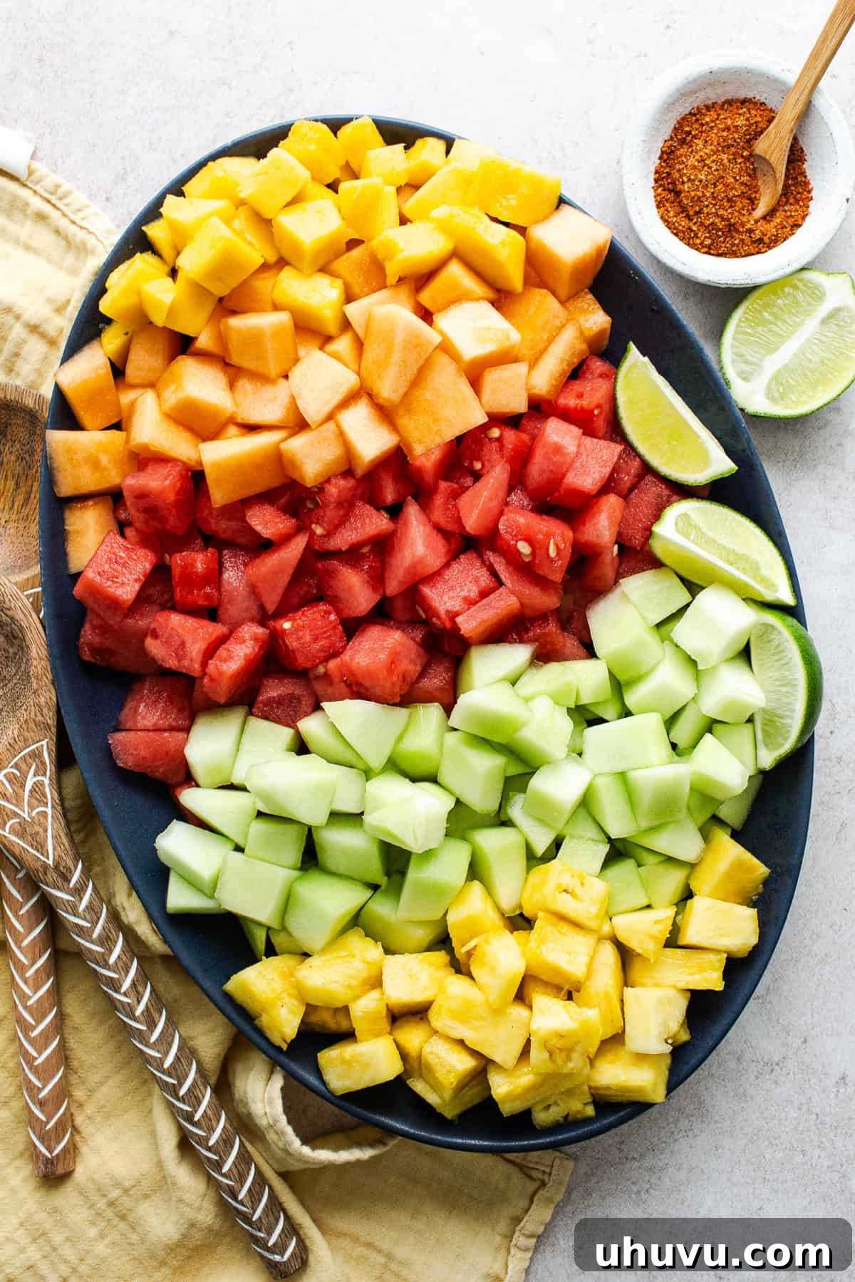 Diced mango, cantaloupe, watermelon, honeydew, and pineapple in a bowl.