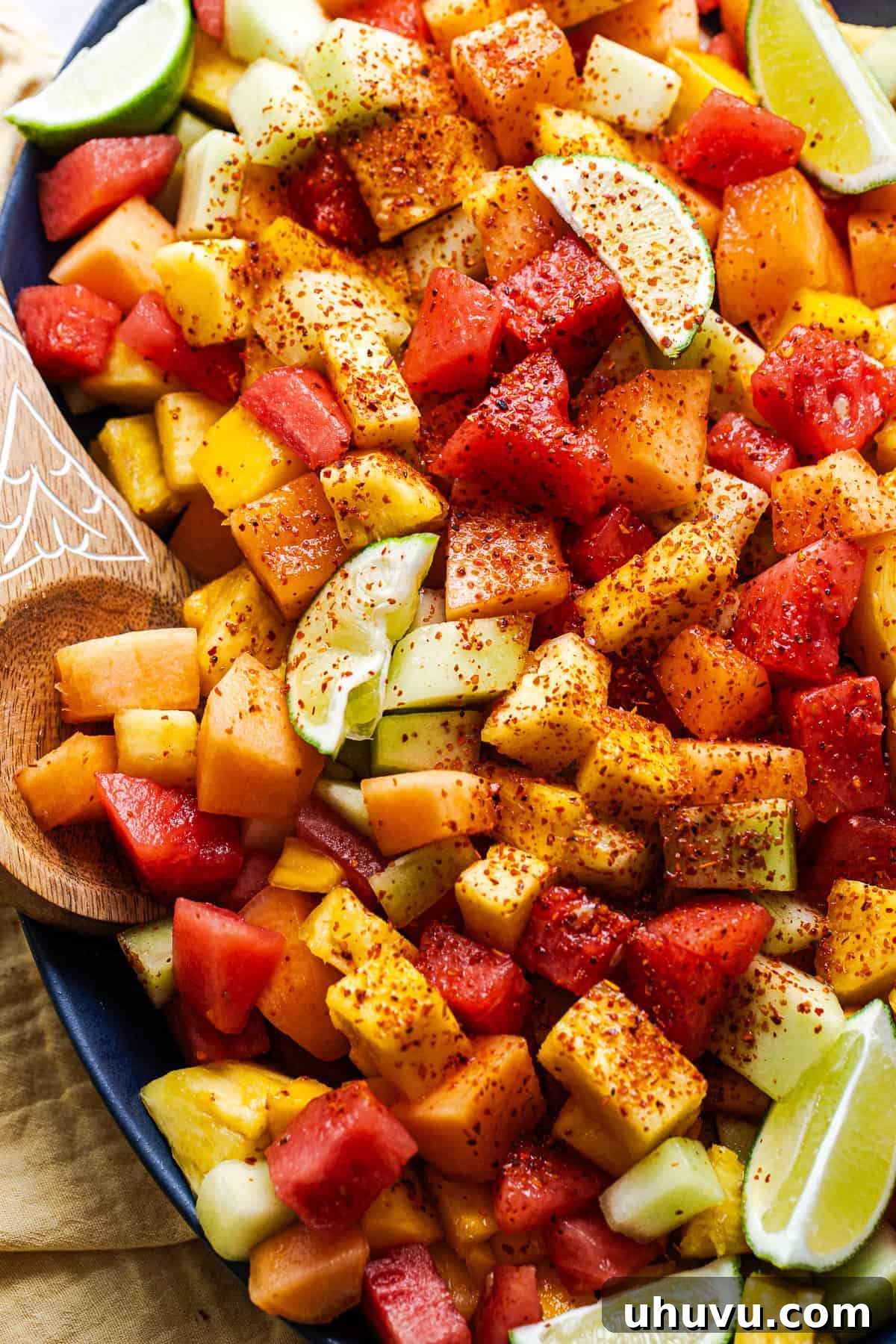 Diced fruit sprinkled with Tajin chili lime seasoning and lime juice.