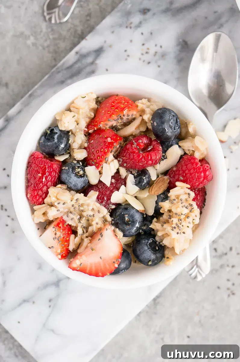 oatmeal topped with berries, almonds and maple syrup
