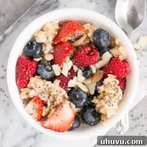 oatmeal topped with berries, almonds and maple syrup