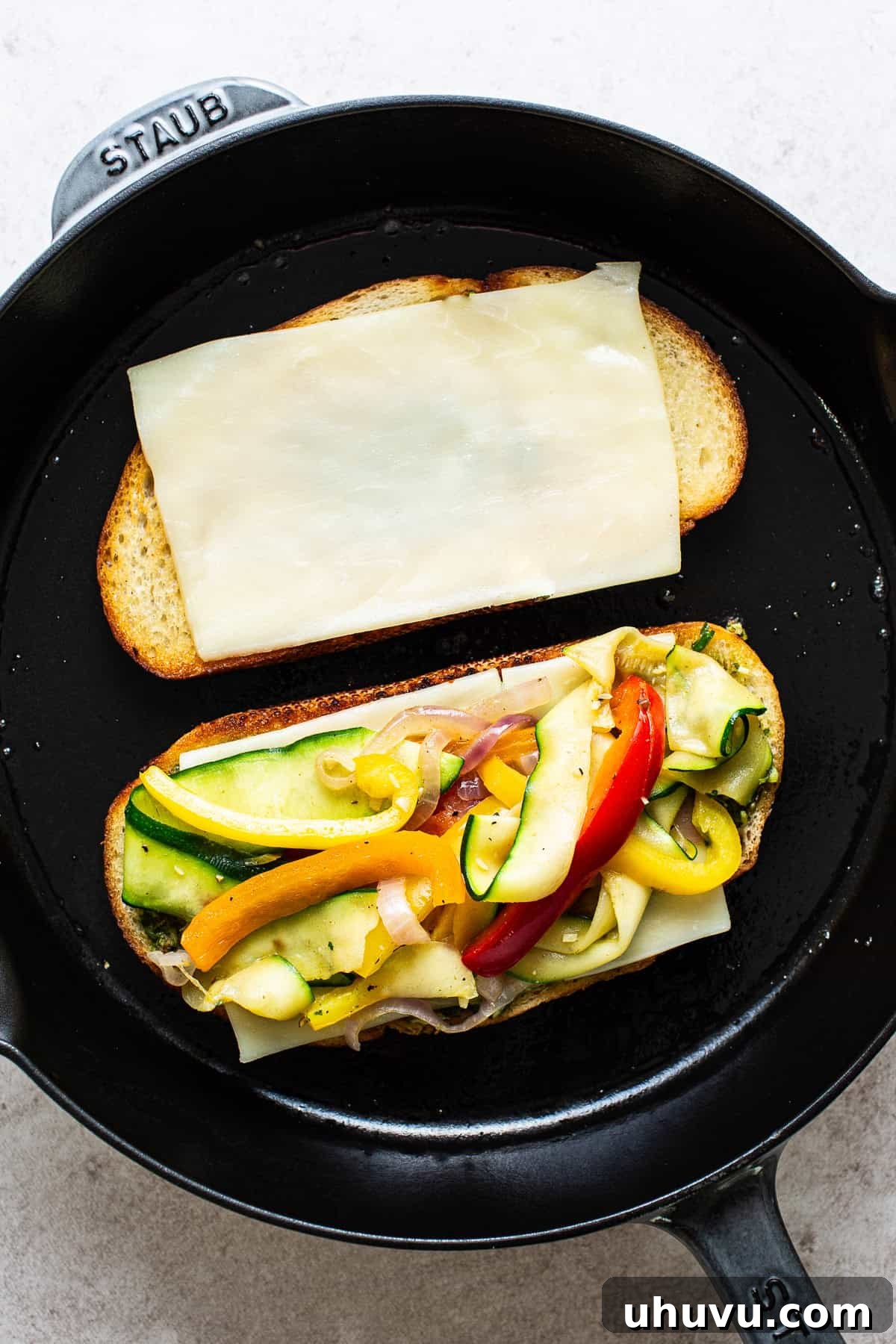 Tex-Mex Grilled Cheese 5 Two slices of bread on a skillet with cheese and the vegetables.
