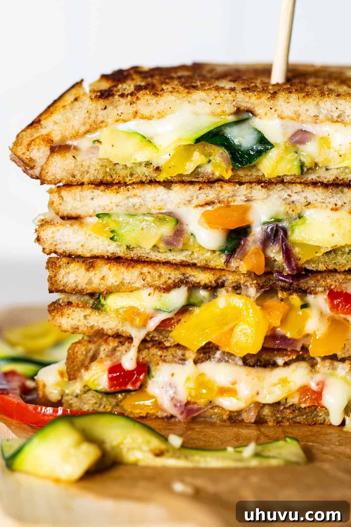 Tex-Mex Grilled Cheese 8 Fajita grilled cheese served on a plate, cut in half, and stacked on top of one another with a skewer in between.