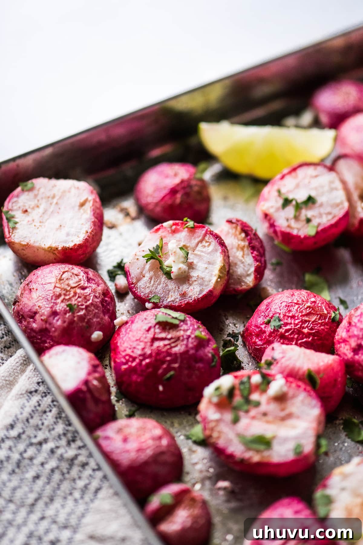 Simple roasted radishes topped with fresh cilantro and crumbled cheese, ready for serving.