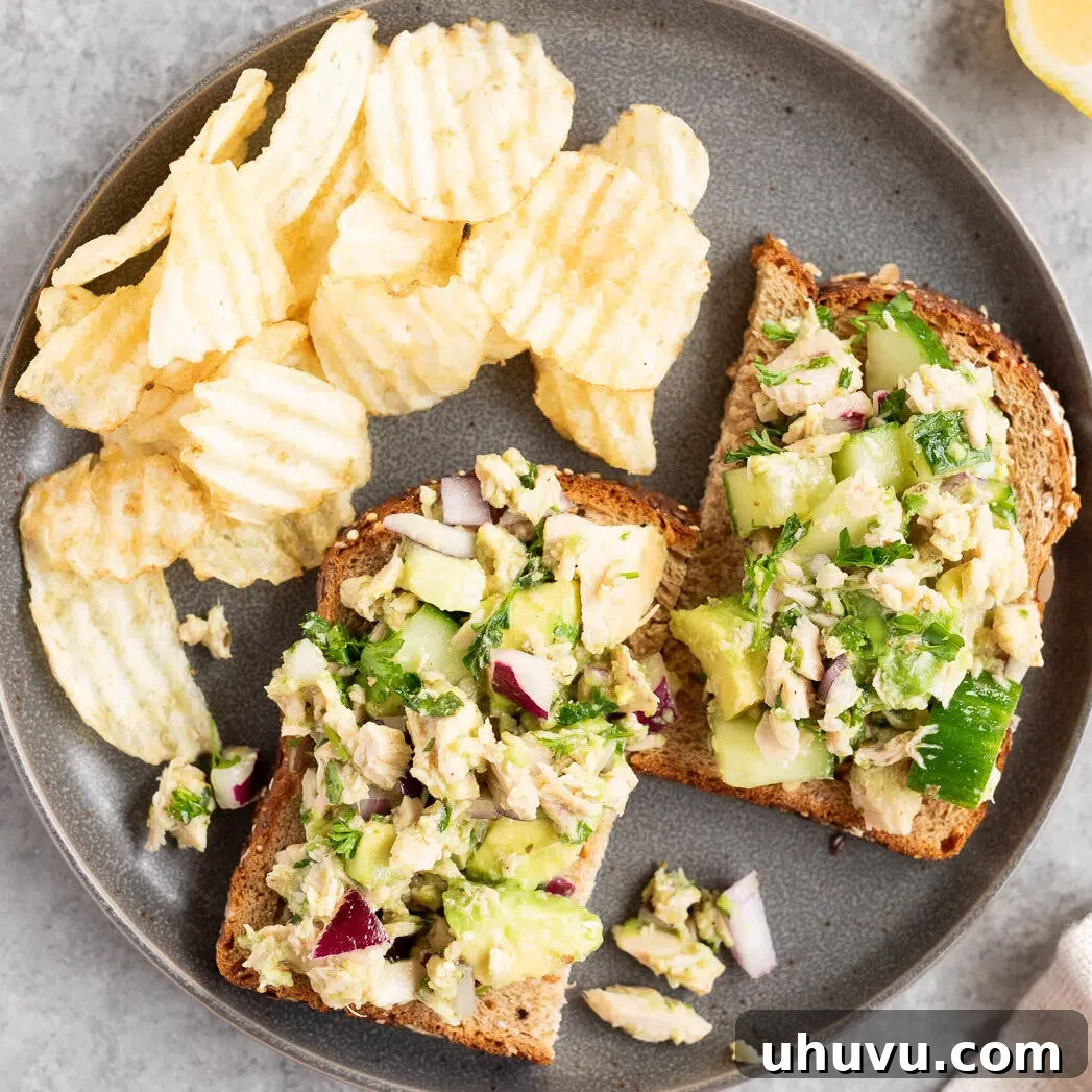 The finished avocado tuna salad served on a crispy piece of toast, ready to be enjoyed.