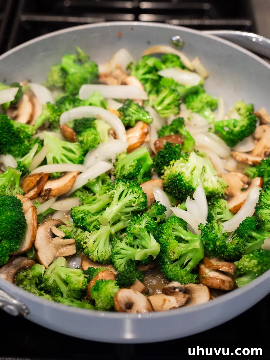 sauteing broccoli, mushrooms and onions in a skillet