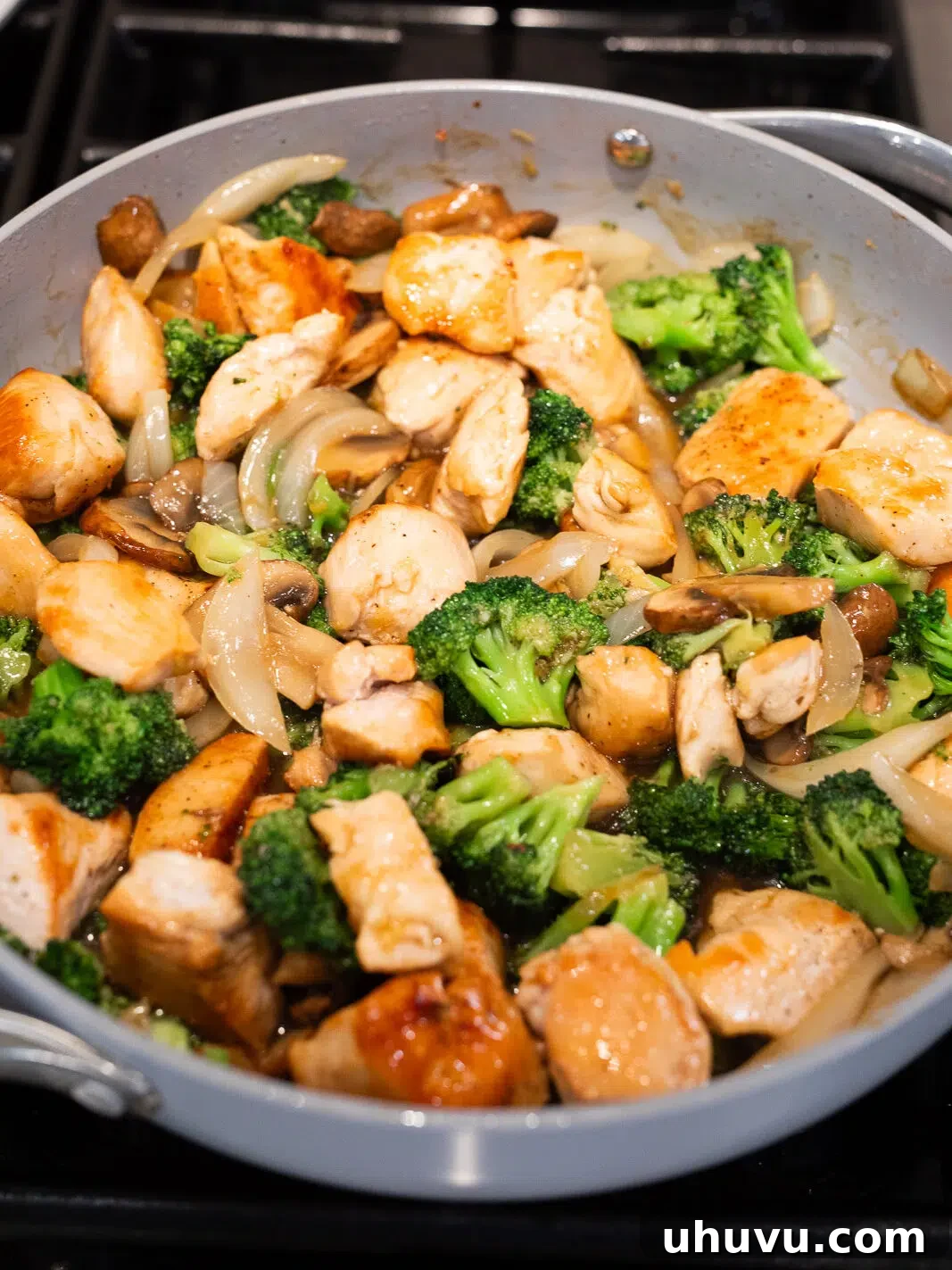 cooking chicken broccoli stir fry in a skillet