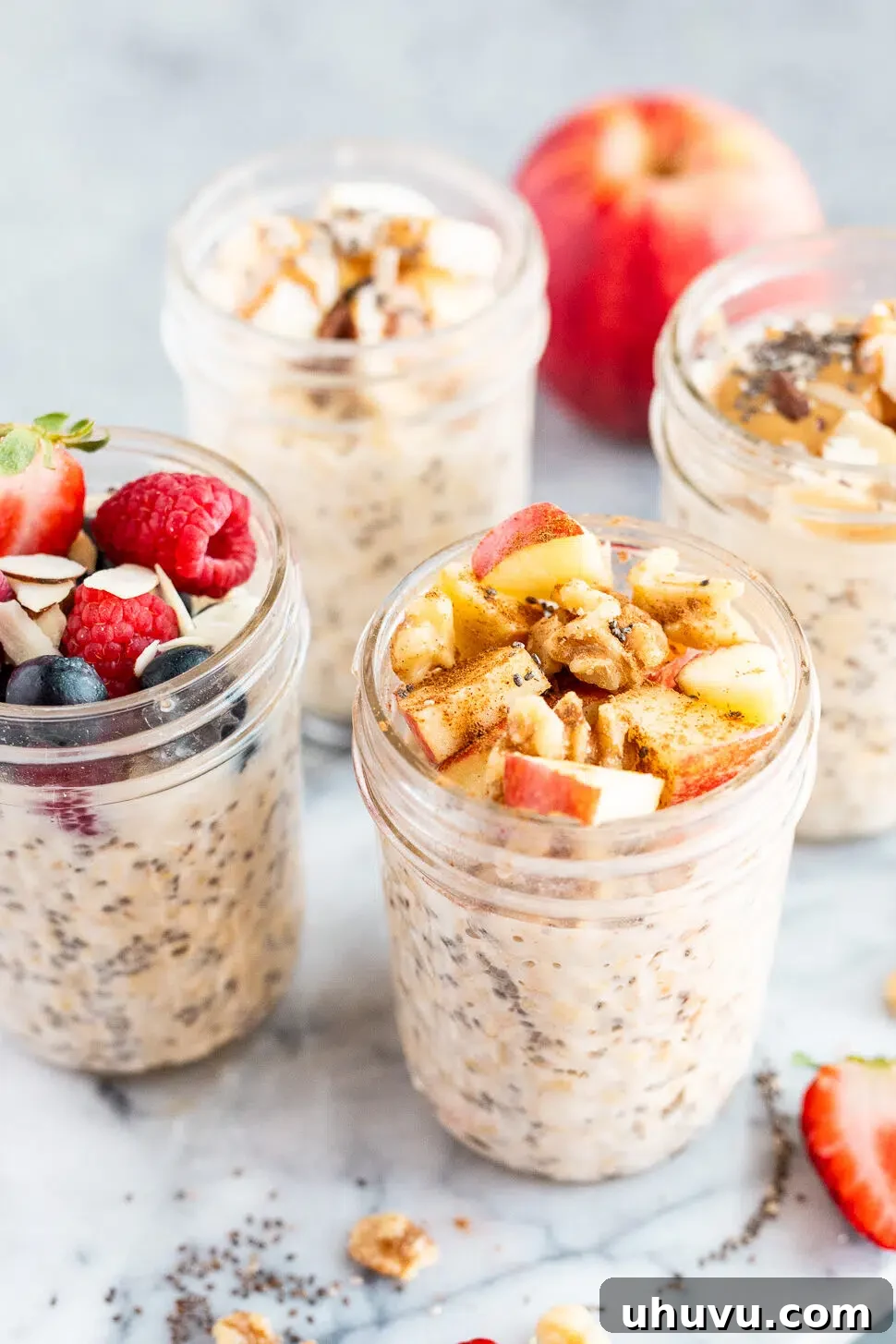 Close-up of thick, creamy overnight oats, enhanced with chia seeds and topped with fresh berries, ready to eat after chilling.