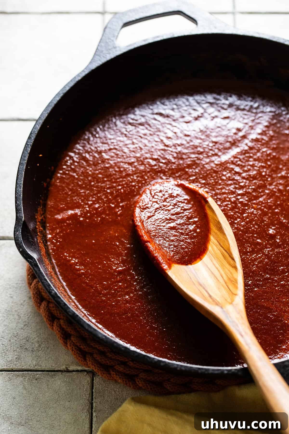 Homestyle Enchilada Red 6 Sauce is simmering in a large skillet